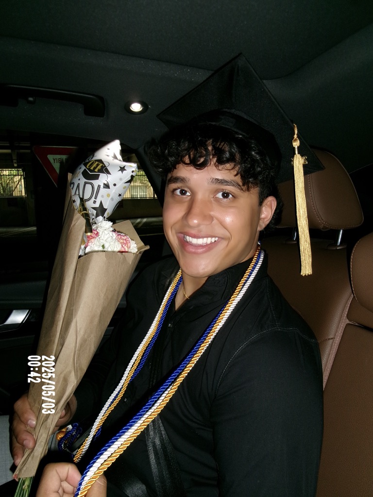 Ethan celebrating graduation in a cap and gown