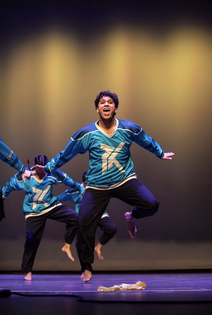 Ethan performing on stage with Purdue Kahaani